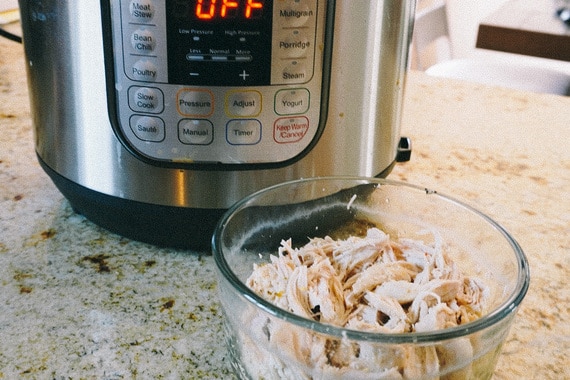 instant pot shredded chicken in front of instant pot appliance