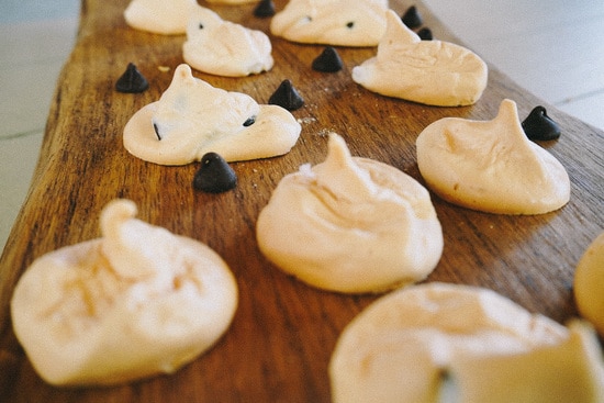 close up of chocolate chip meringue cookies on a cutting board