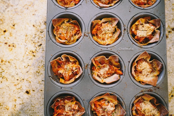baked chicken parmesan in a muffin tin after baking