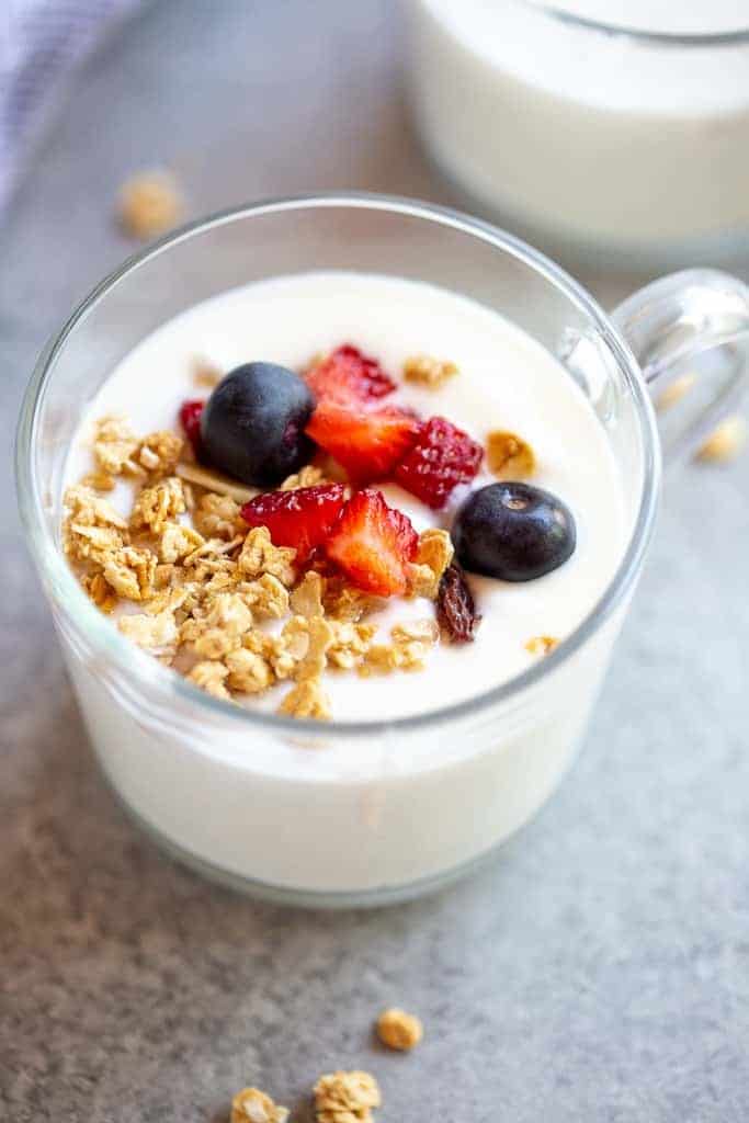 yogurt in a cup with berries and granola