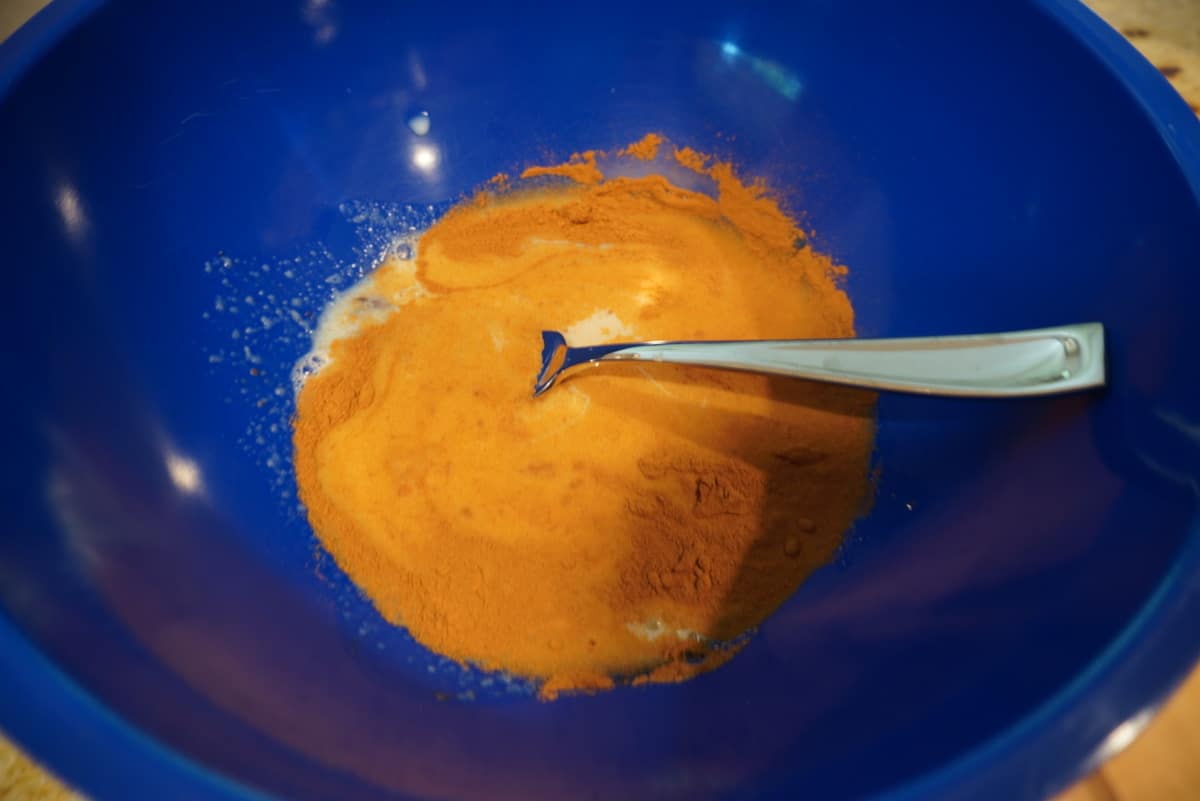 mixed churro bite batter in a blue bowl