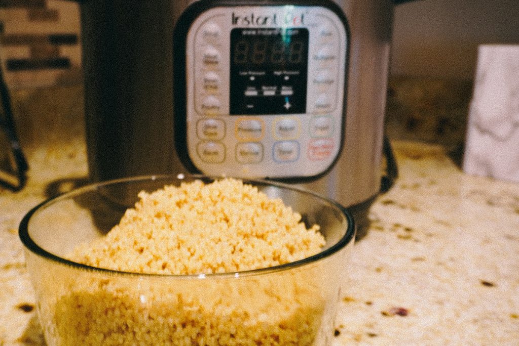 quinoa in a bowl in front of the instant pot