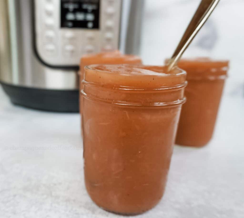 close up of apple butter with a spoon