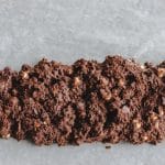 chocolate macadamia biscotti log on parchment paper