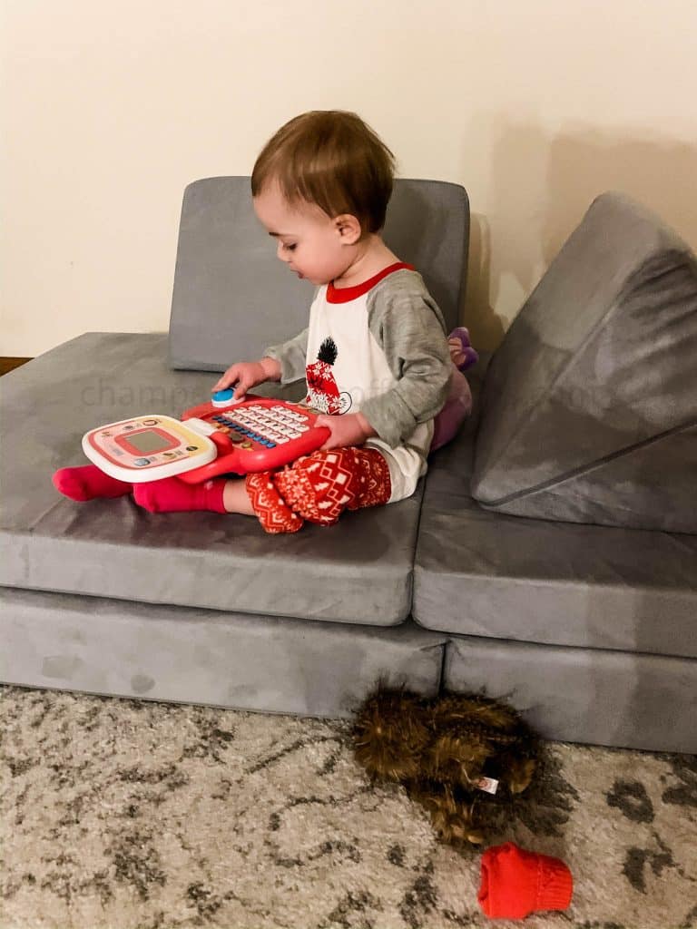 kid playing on a nugget couch
