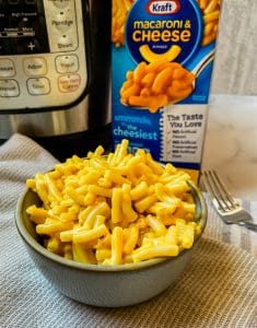 bowl of kraft macaroni and cheese in front of an instant pot