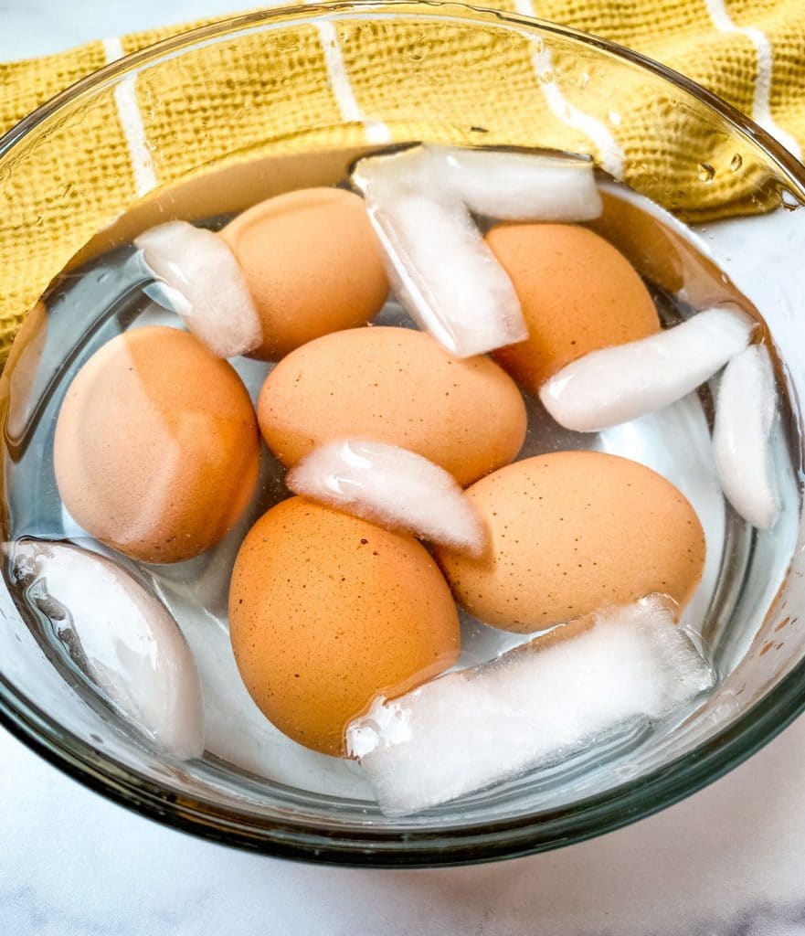 finished hard boiled eggs in a bowl of ice water