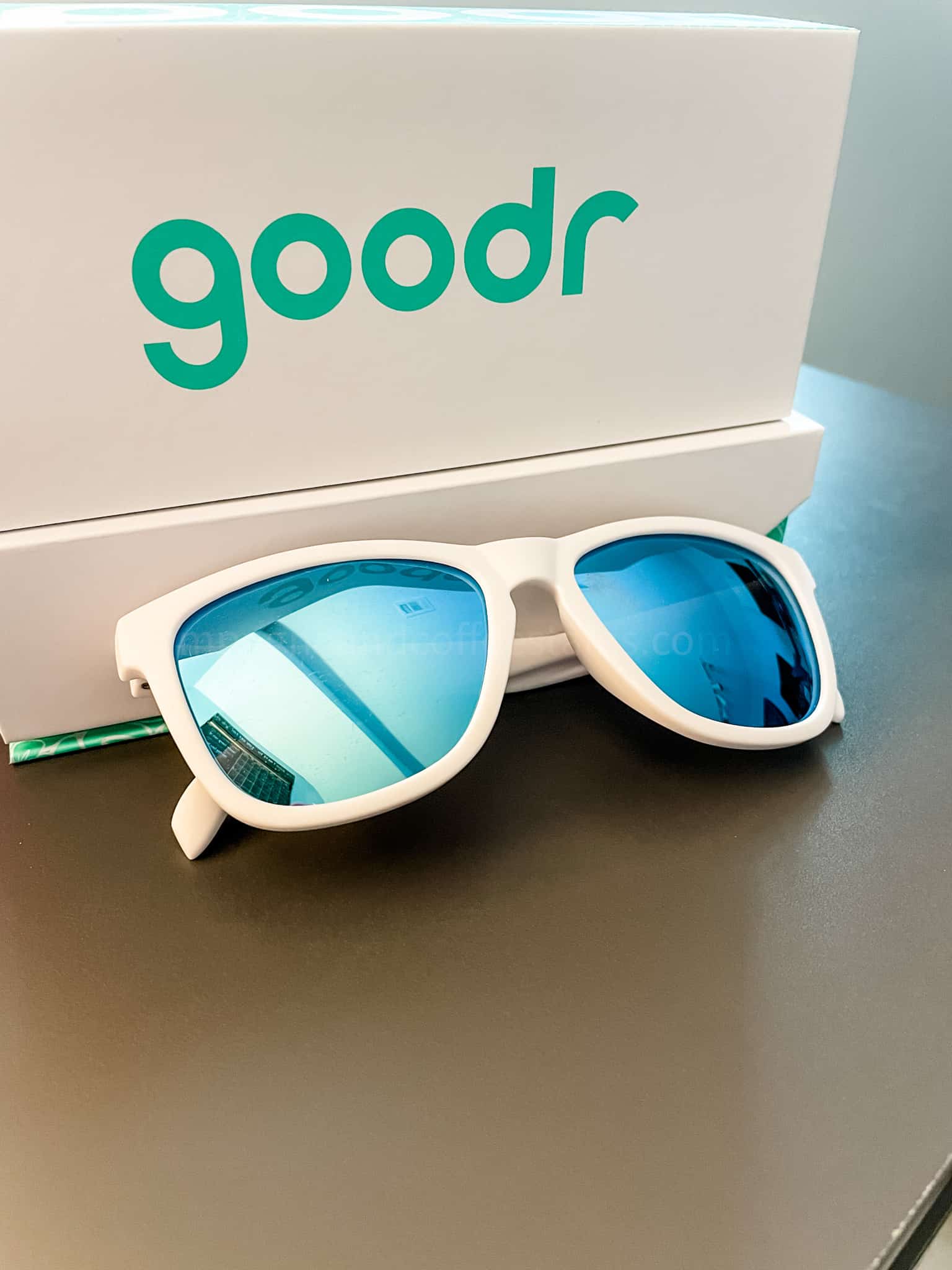white goodr sunglasses in front of box