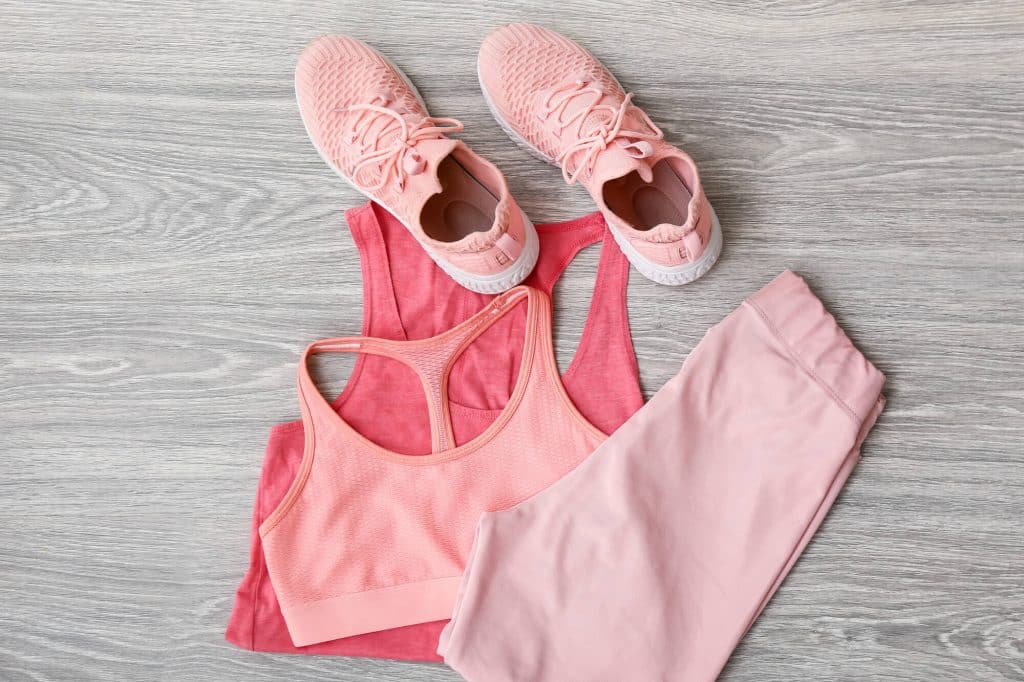 flat lay of pink running leggings, shoes and a top