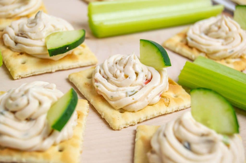 veggie cream cheese spread crackers on a plate