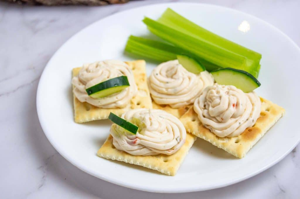 veggie cream cheese spread crackers on a plate