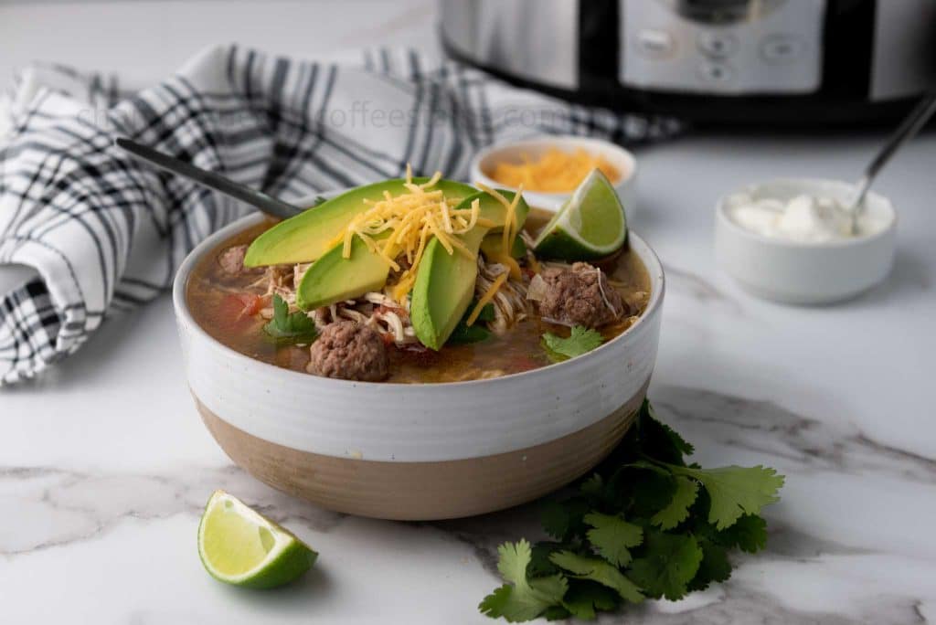 taco soup in a bowl with toppings