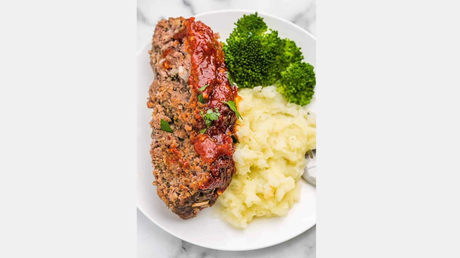 meatloaf with broccoli and mashed potatoes on a plate