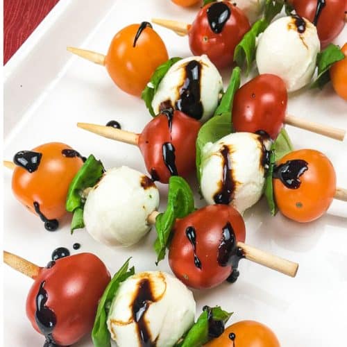 caprese skewers with glaze on a white plate