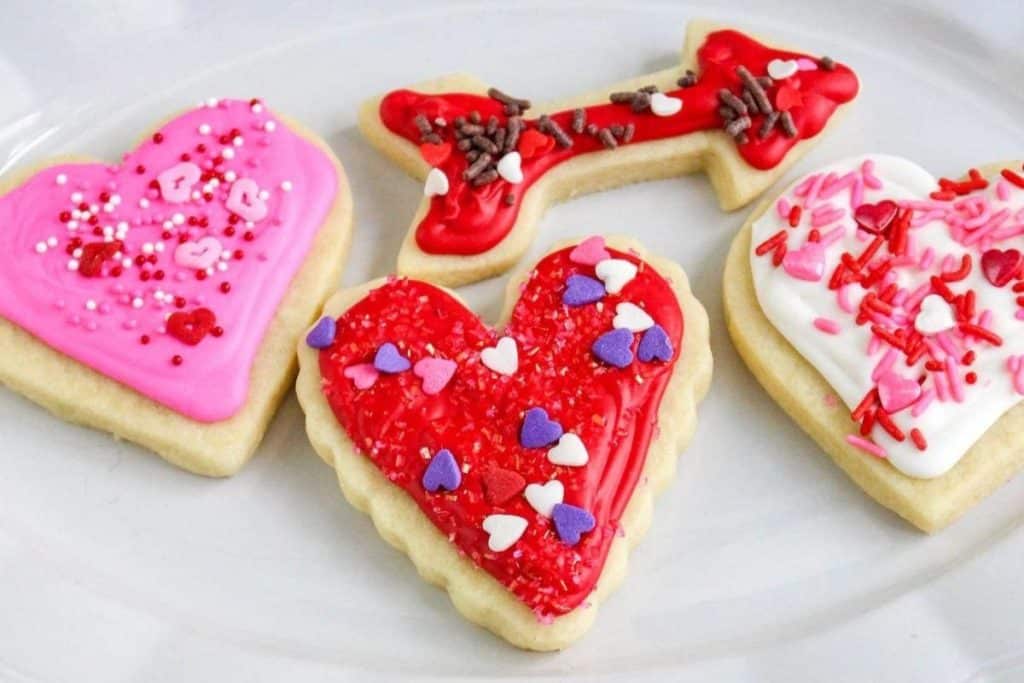 frosted heart and arrow cut-out cookies with sprinkles