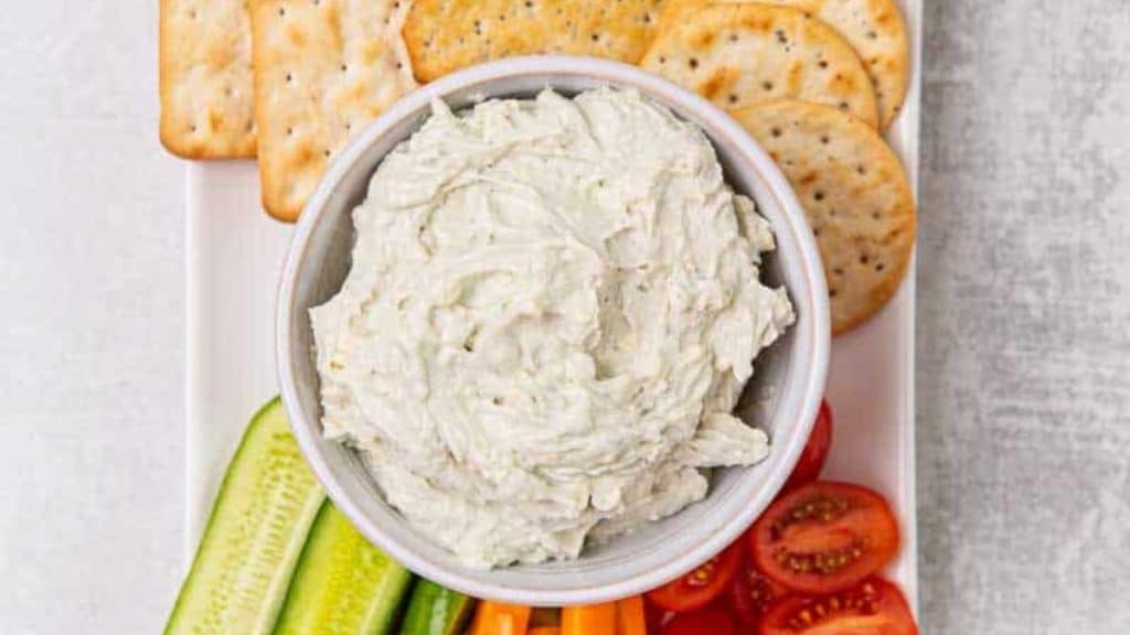Blue Cheese Dip with veggies and crackers around it 