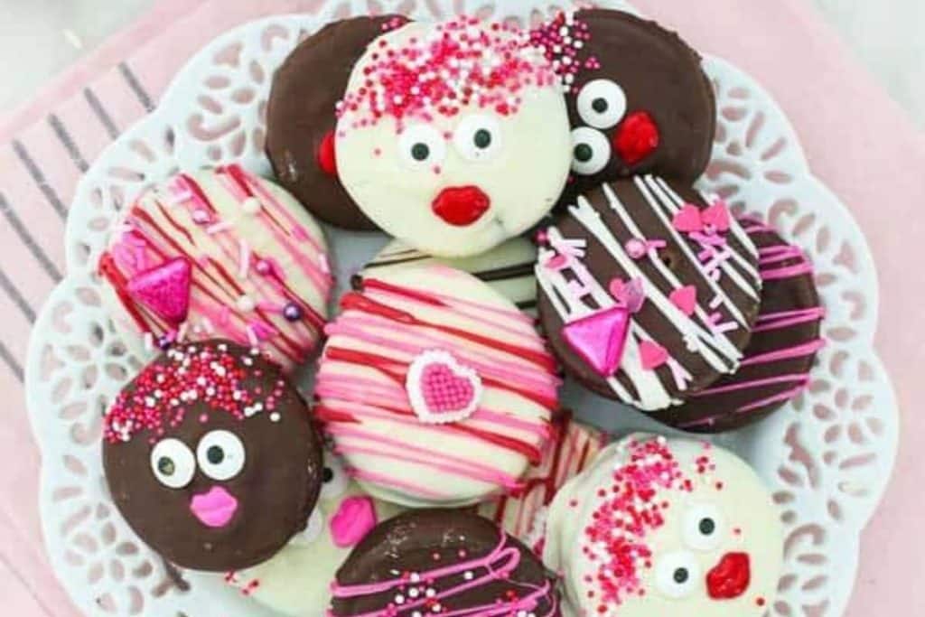chocolate covered oreos with cute faces or red and pink chocolate drizzle